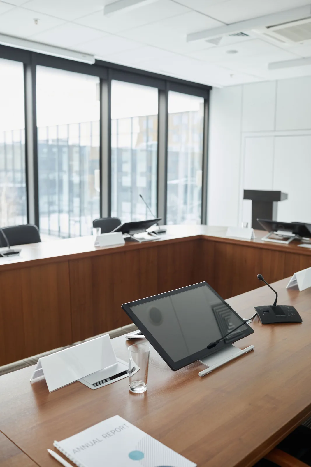Conference room with installed displays and tabletop microphones