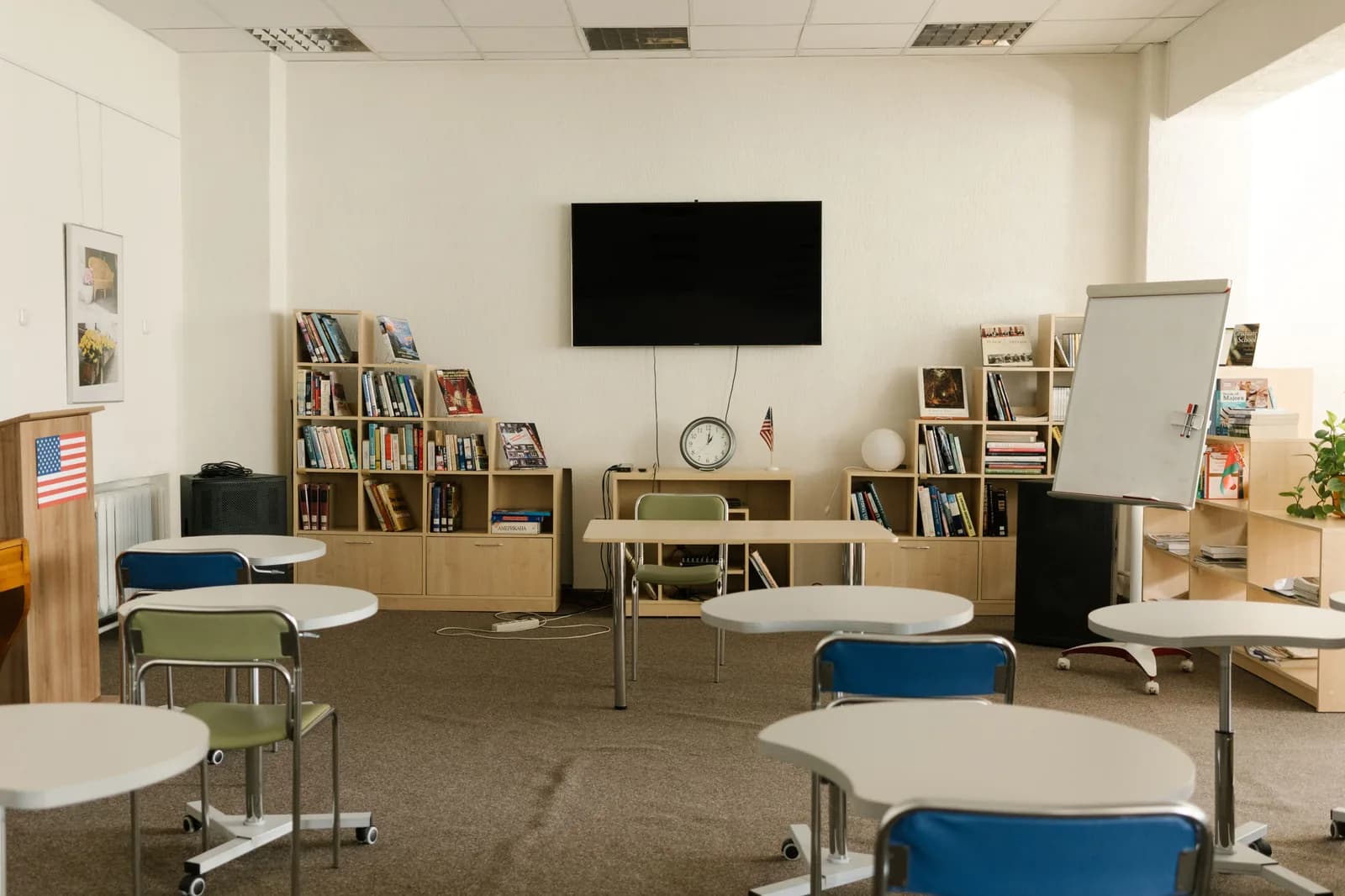 Empty classroom with a wall display and teaching furniture
