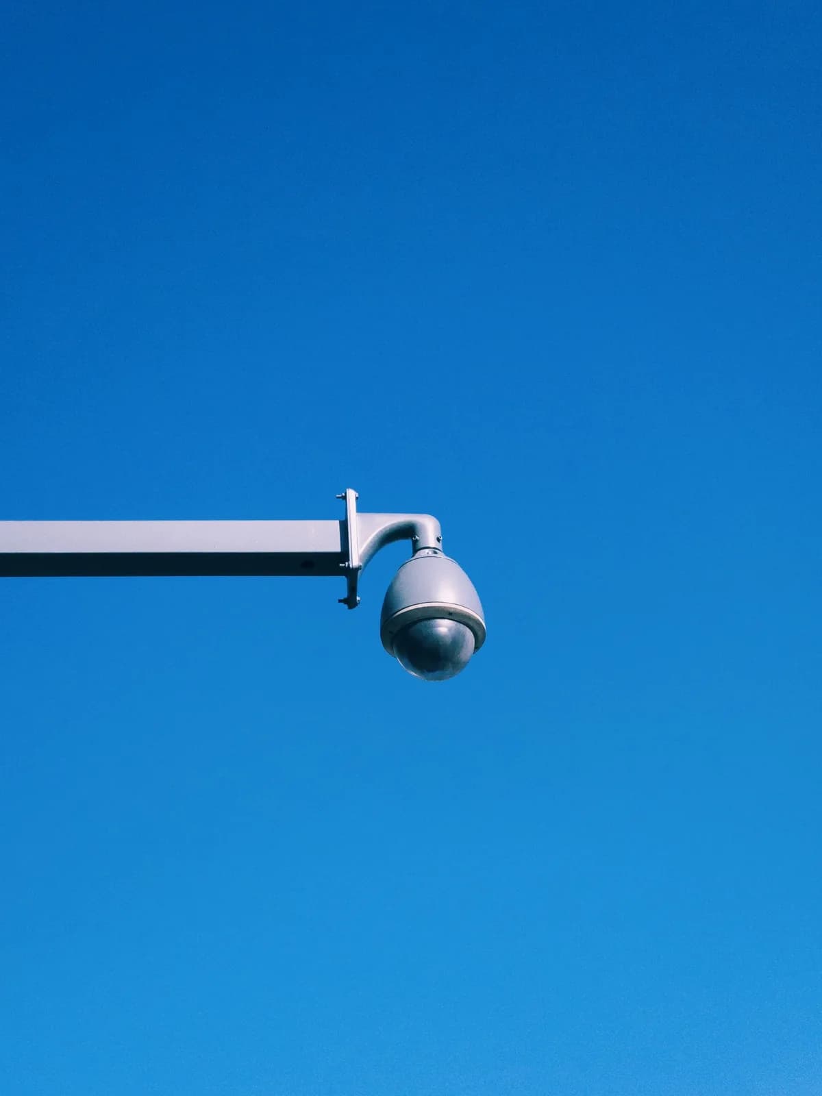 Commercial surveillance camera mounted on an exterior arm